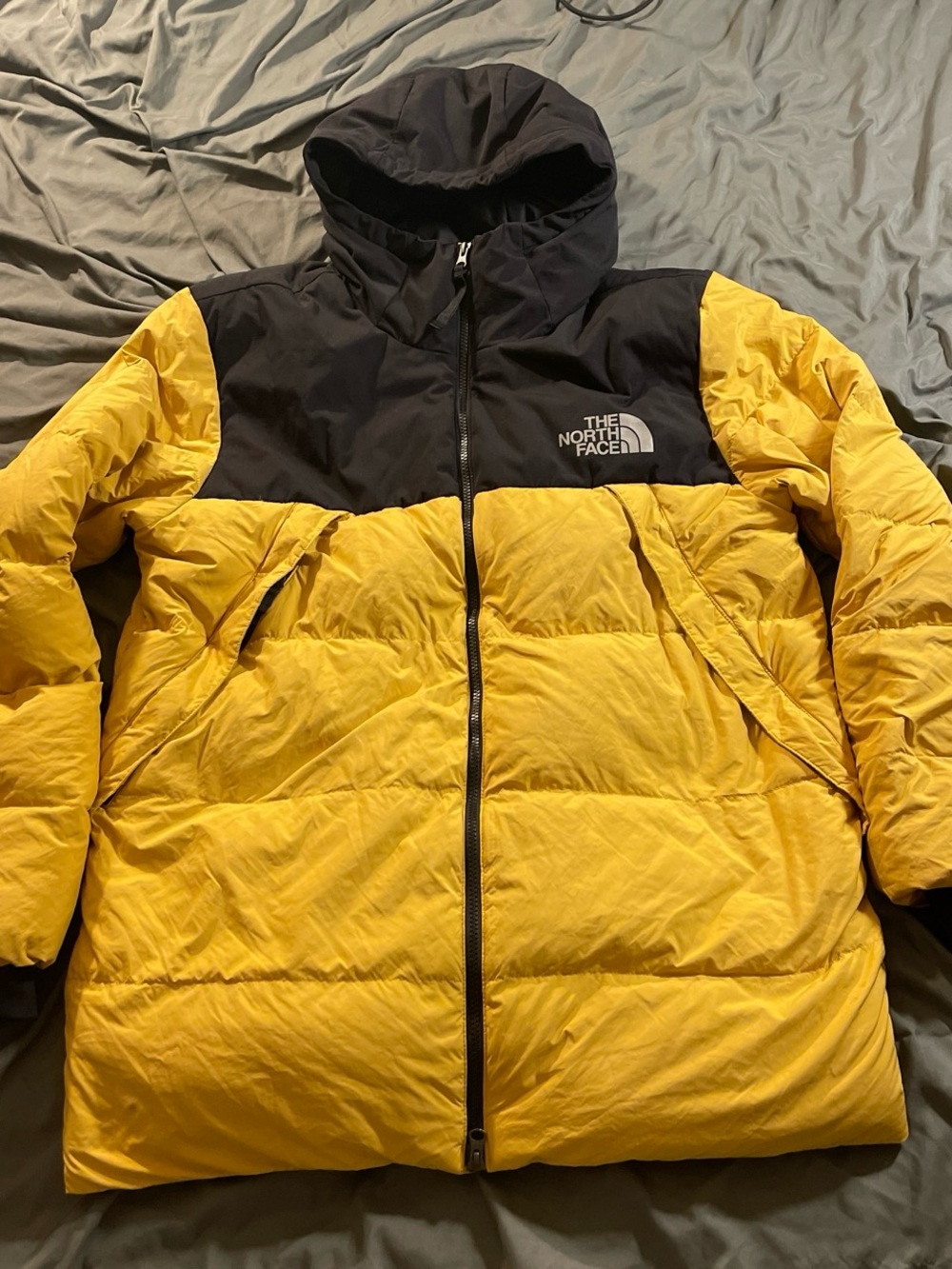 The North Face 550 yellow puffer jacket with black hood